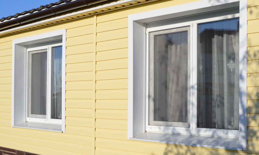 How does the lifespan of vinyl compare to wood windows?