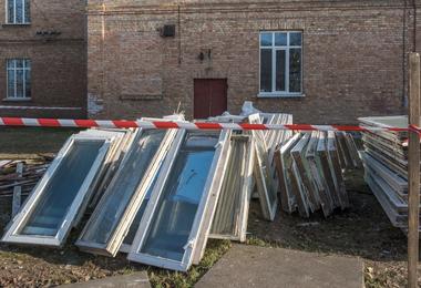 Pile of old wooden window frames prepared for recycling outdoors in Canada