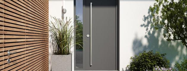 Modern entry door with canopy and plants at a Toronto home