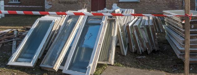 Pile of old wooden window frames prepared for recycling outdoors in Canada
