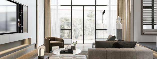 Modern living room with floor-to-ceiling windows bringing abundant natural light and outdoor views