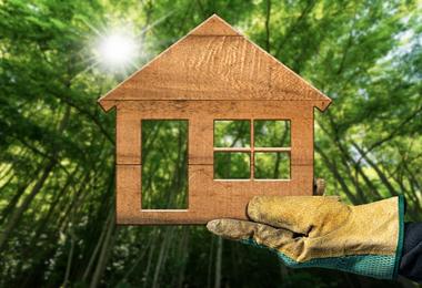 Gloved hand holding eco-friendly window frame sample — representing sustainable materials for Canadian homes.