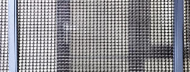 Close-up of a storm door showing weatherstripping and glass panel