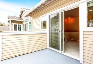 Opened standard patio doors leading to a backyard deck in a Canadian home