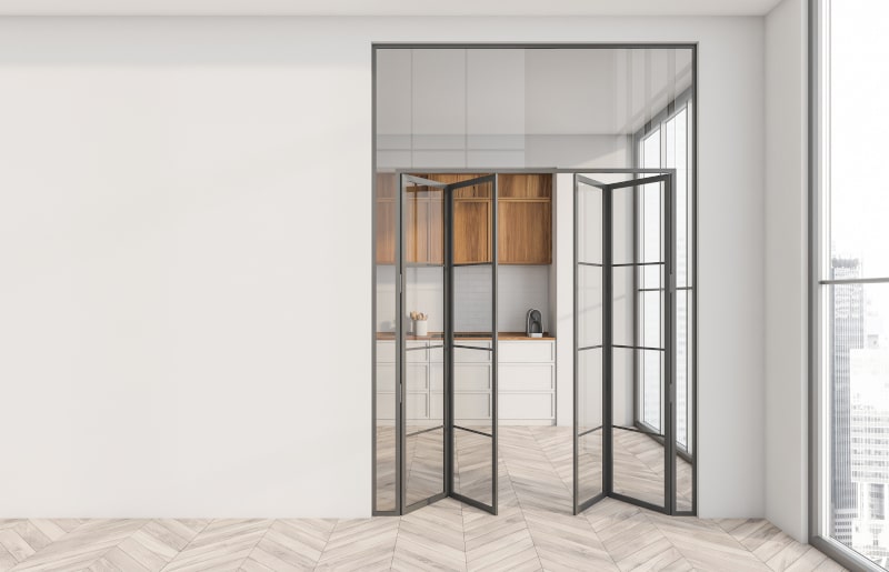 Glass-framed folding (bi-fold) doors in an industrial-style space