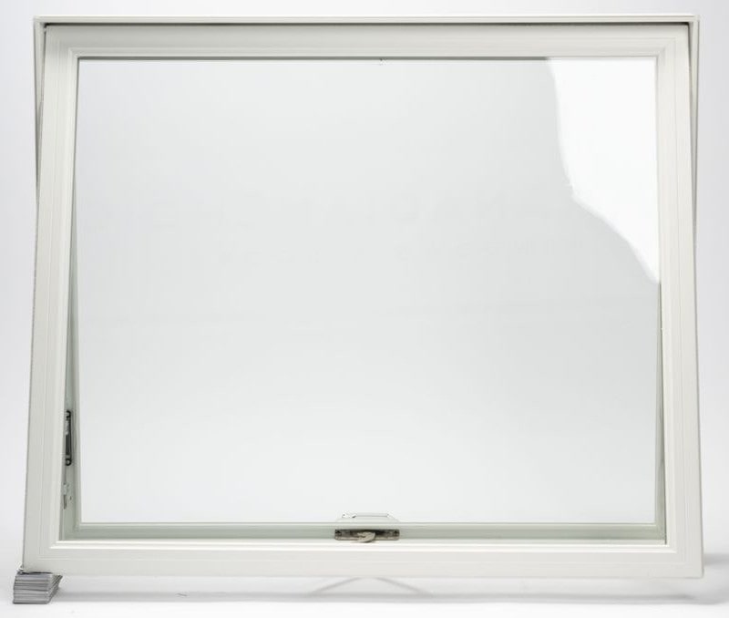 Homeowner cleaning the upper window from inside the room