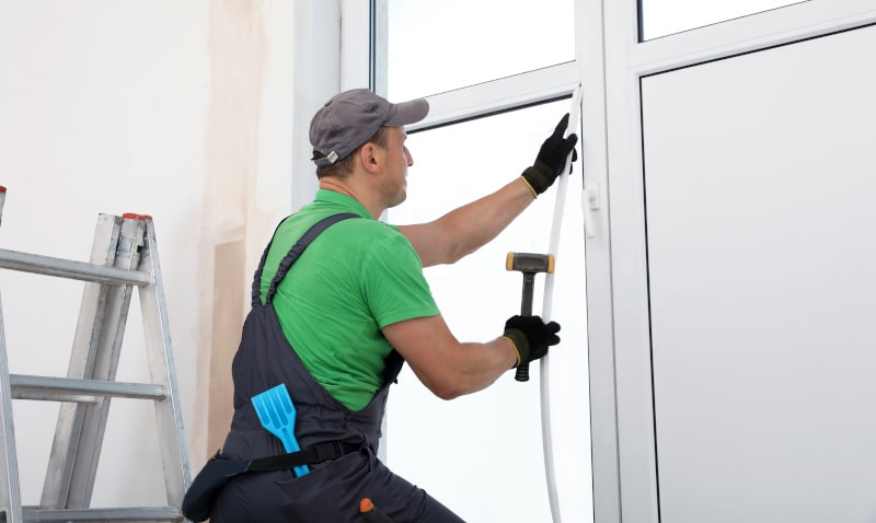 Professional installer working on a soundproof window installation