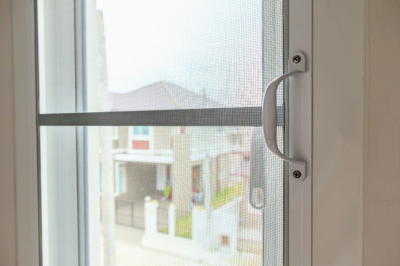 Close-up of mosquito net screen installed on a house window